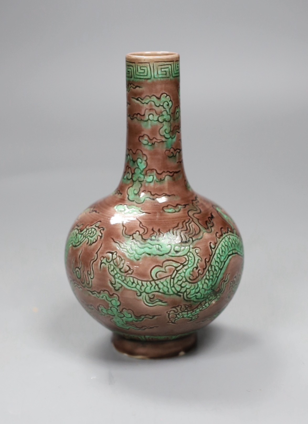 A Chinese aubergine and green glazed 'dragon' bottle vase, 14cm tall